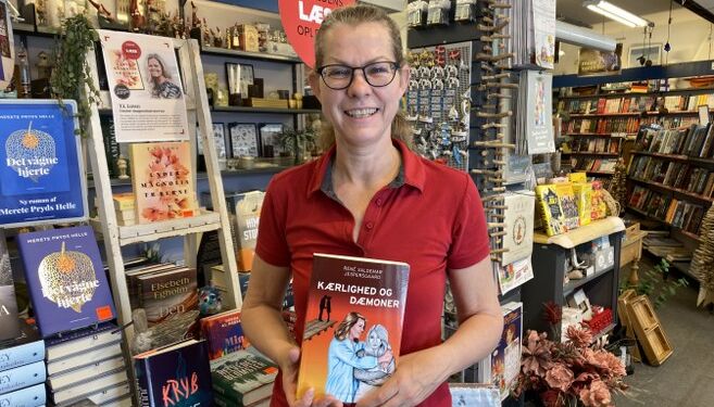 Boghandler Malene Ibsen Jakobsen med et eksemplar af Kærlighed og dæmoner.
