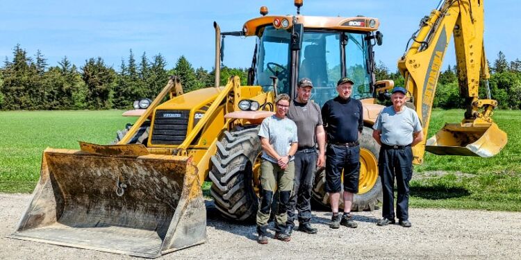 Kristina, Thomas og Tommy sammen med Kjeld og hans gule rendegraver, der nu er en del af Tversted Smedie & Entreprenør.