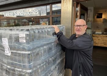Butiksbestyrer Jan Hansen med det krystalklare vand fra fjeldet Kirvi på Færøerne. Foto: Niels Skipper.