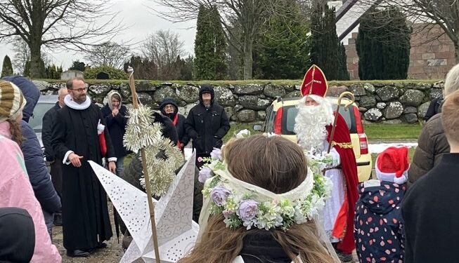 Sognepræsten, jule-englen og julemanden foran Tversted Kirke. Foto (arkiv): Palle W. Nielsen