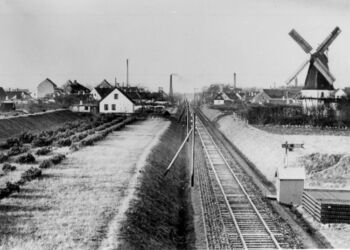 Fra Johanne Breunings erindringsfortælling om en barndom i Bredfald Mølle ved Frederikshavnsvej. Billedet er taget ind over Hjørring fra øst. Midt i billedet er statsbanen. Til højre for banen ses Bredfald Mølle. Fabriksskorstene er fra venstre gasværket, andelssvineslagteriet (uden røg),  Arbejdernes Fællesbageri (med røg) og mejeriet Katrinelund. Foto: Historisk Arkiv, Vendsyssel Historiske Museum.