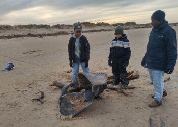 Familien Høgsted Yakubu ved hvalknoglen på Tversted Strand. Foto: Privat.