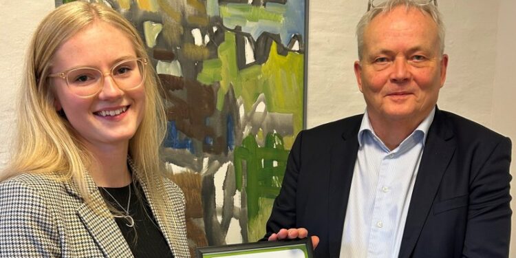 Formand for fonden, advokat Palle Møller Jørgensen overrækker legatet til Julie Stride. Hendes kæreste Victor var desværre forhindret. Foto: Sparekassen Danmark.
