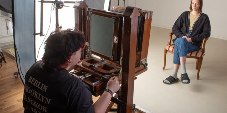 Anne-Sofie er i gang med at indstille fokusset med skolens 170 årige gamle analoge kamera. Foto: Vrå Højskole.